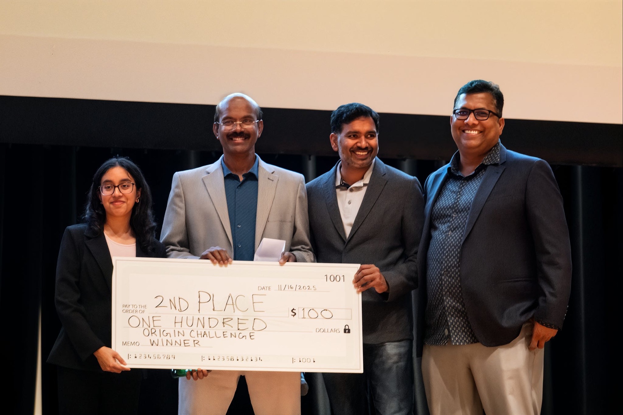 Second place team receiving their prize check at Project Origin