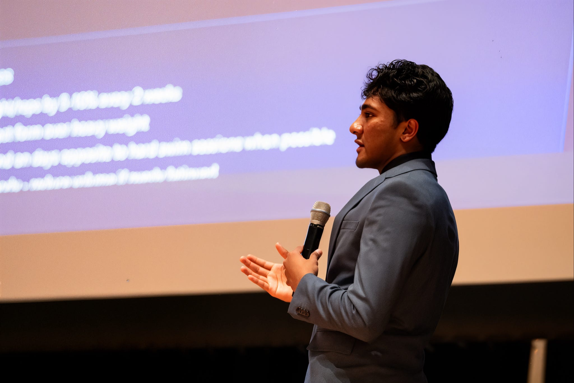 A finalist pitching live on stage at the Project Origin pitch competition