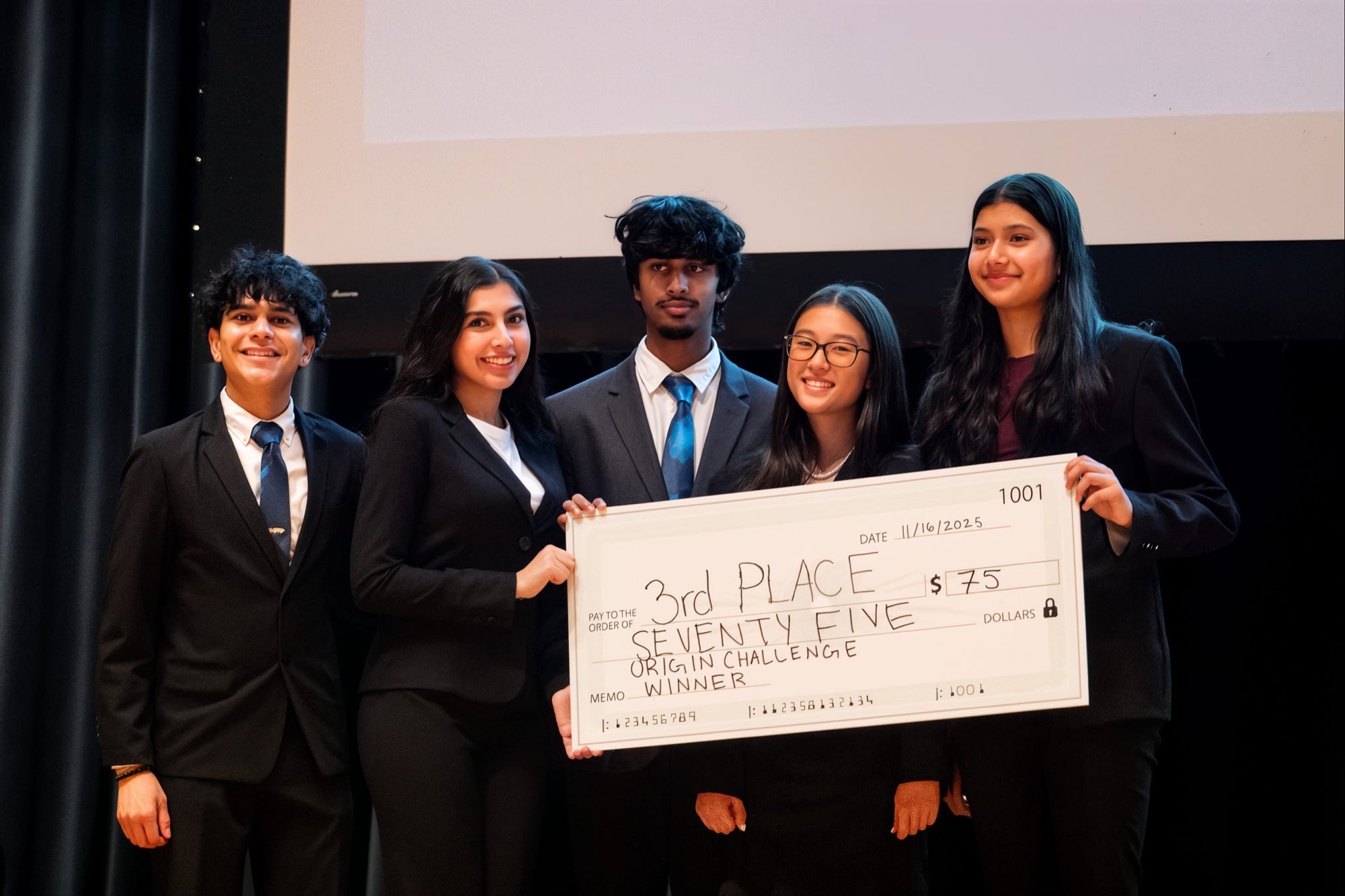 Third place team receiving their prize check at Project Origin